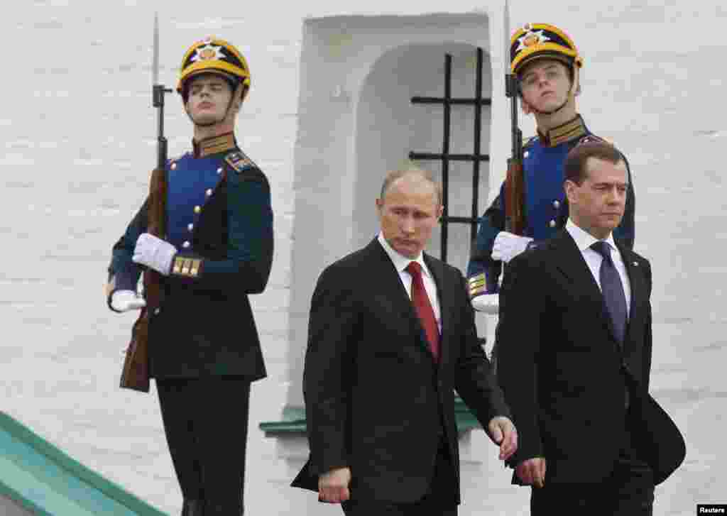 New Russian President Vladimir Putin (left) and former President Dmitry Medvedev after Putin&#39;s inauguration ceremony at the Kremlin. Putin appealed for unity in Russia amid ongoing protests against his continued rule. (Reuters/Dmitry Astakhov)
