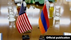 Armenia - U.S. and Armenian national flags placed on a negotiating table in Yerevan, 18Dec2013.