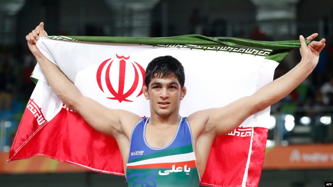 Iran's Hassan Aliazam Yazdanicharati celebrates after winning against Russia's Aniuar Geduev in their men's 74kg freestyle final match.