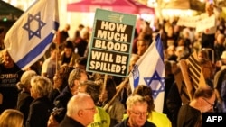 Israeli left-wing activists demonstrate on HaBima Square against the ongoing war with Iran and against the Israeli government, in Tel Aviv on May 2.