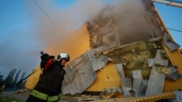 A firefighter works at the site of a tobacco factory damaged during a Russian drone strike in Kyiv on May 28.