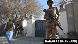 A Pakistani security personnel stands guard during the Christmas Day mass in Quetta on December 25 following a suicide bombing several weeks before.