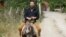 Russian businessman German Sterligov rides a donkey in Nagorno-Karabakh, 7Jul2015.