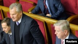 Former Polish President Aleksander Kwasniewski (second left) and former European Parliament President Pat Cox (right) attend a session of the Ukrainian parliament in Kyiv on November 8.
