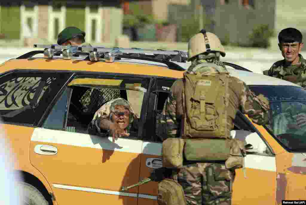 An Afghan woman cries inside a car near a mosque that was hit by a deadly bomb explosion in the Shakar Dara district of Kabul on May 14. (AP/Rahmat Gul)