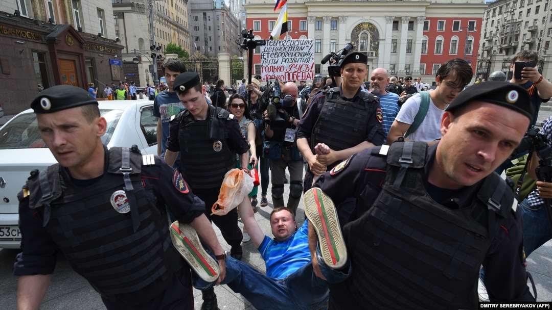 Russian riot police detain gay rights activist Nikolai Alekseyev during an unauthorized gay-rights rally in central Moscow in May.