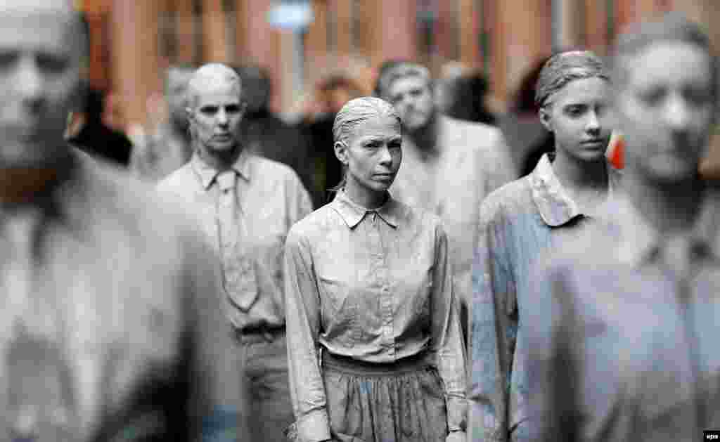 Protesters dressed up in gray clothes like zombies take part in an art demonstration against apathy prior to the upcoming G20 summit in Hamburg, Germany. (epa/Friedemann Vogel)