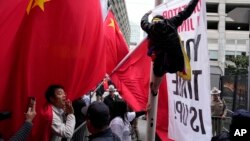 Supporters and critics of Chinese President Xi Jinping converge near the site of the 2023 APEC Summit in San Francisco. 