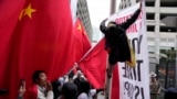 Supporters and critics of Chinese President Xi Jinping converge near the site of the 2023 APEC Summit in San Francisco. 