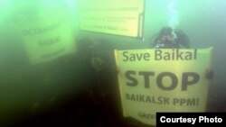 Greenpeace activists dive into Lake Baikal to protest a polluting paper mill 