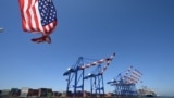A US flag flies off the stern of a tour boat at the Port of Los Angeles, California, on July 31, 2025.