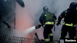 Firefighters in Ukraine's Dnipropetrovsk region tackle a blaze following a Russian missile strike on December 25. 