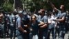 Armenia -- Riot police detain a supporter of Prosperous Armenia Party leader Gagik Tsarukian outside the National Security Service headquarters in Yerevan, June 14, 2020.