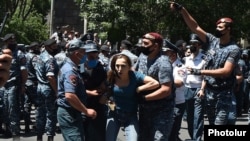 Armenia -- Riot police detain a supporter of Prosperous Armenia Party leader Gagik Tsarukian outside the National Security Service headquarters in Yerevan, June 14, 2020.