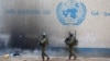 Israeli soldiers walk inside an evacuated compound of the United Nations Relief and Works Agency for Palestine Refugees (UNRWA) in the Gaza Strip. (file photo)