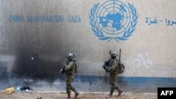 Israeli soldiers walk inside an evacuated compound of the United Nations Relief and Works Agency for Palestine Refugees (UNRWA) in the Gaza Strip. (file photo)