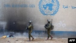 Israeli soldiers walk inside an evacuated compound of the United Nations Relief and Works Agency for Palestine Refugees (UNRWA) in the Gaza Strip. (file photo)