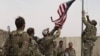 U.S. troops take down their country's flag as part a ceremony held to hand over an American base to local defense forces in May. Afghanistan was overrun by the Taliban just a few months later, shortly before the United States had fully completed its withdrawal. 