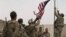 U.S. troops take down their country's flag as part a ceremony held to hand over an American base to local defense forces in May. Afghanistan was overrun by the Taliban just a few months later, shortly before the United States had fully completed its withdrawal. 