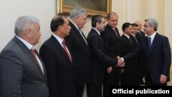 Armenia - President Serzh Sarkisian greets Azerbaijani Interior Minister Ramil Usubov (third from right) and police chiefs from other former Soviet republics who met in Yerevan on October 14, 2011.