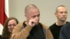 Vital Bandaruk (center) and Larisa Shchyrakova (left) weep as a choir sings a Belarusian folk song at a news conference in Vilnius on September 12, where they and other newly freed prisoners recounted repression and torture behind bars.