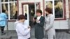 Galina Arzamasova (center) stands outside the Talghar district court on March 17.