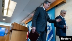 U.S. Secretary of State Antony Blinken (left) and Israeli Foreign Minister Yair Lapid leave after a news conference at Israel's Ministry of Foreign Affairs in Jerusalem on March 27.