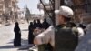 SYRIA -- A Russian military policeman stands guard as displaced Syrian women who are staying at a temporary shelter in Jibrin, on the outskirts of Aleppo, gather before being transported to areas currently controlled by the Syrian regime in eastern Aleppo