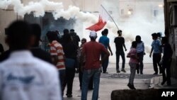 Bahraini Shi'ite youth protest in solidarity with jailed dissident Abdel Hadi Khawaja and prominent rights activist Nabeel Rajab, in Bilad Al-Qadeem, a suburb of Manama, on May 17.