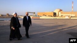 Iranian President Hassan Rohani (left) walks with Iran's Atomic Energy chief Ali Akbar Salehi at the Bushehr nuclear power plant. (file photo)