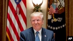 President Donald Trump smiles during a luncheon with members of the United Nations Security Council in the Cabinet Room at the White House in Washington, Thursday, Dec. 5, 2019. (AP Photo/Andrew Harnik)