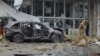 An investigator walks near a damaged store after shelling in the occupied city of Donetsk which local Russian-installed authorities called a Ukrainian military strike on January 10. 