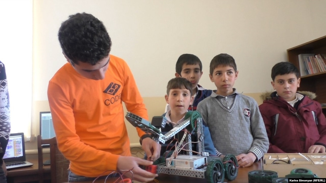 Vazgen Hovhannisian (left), a 16-year-old computer-game designer, works on a robot during a computer club meeting in the Armenian village of Aygek. 