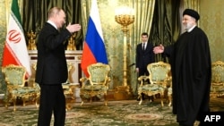 Russian President Vladimir Putin (left) greets his Iranian counterpart, Ebrahim Raisi, in Moscow on December 7. 