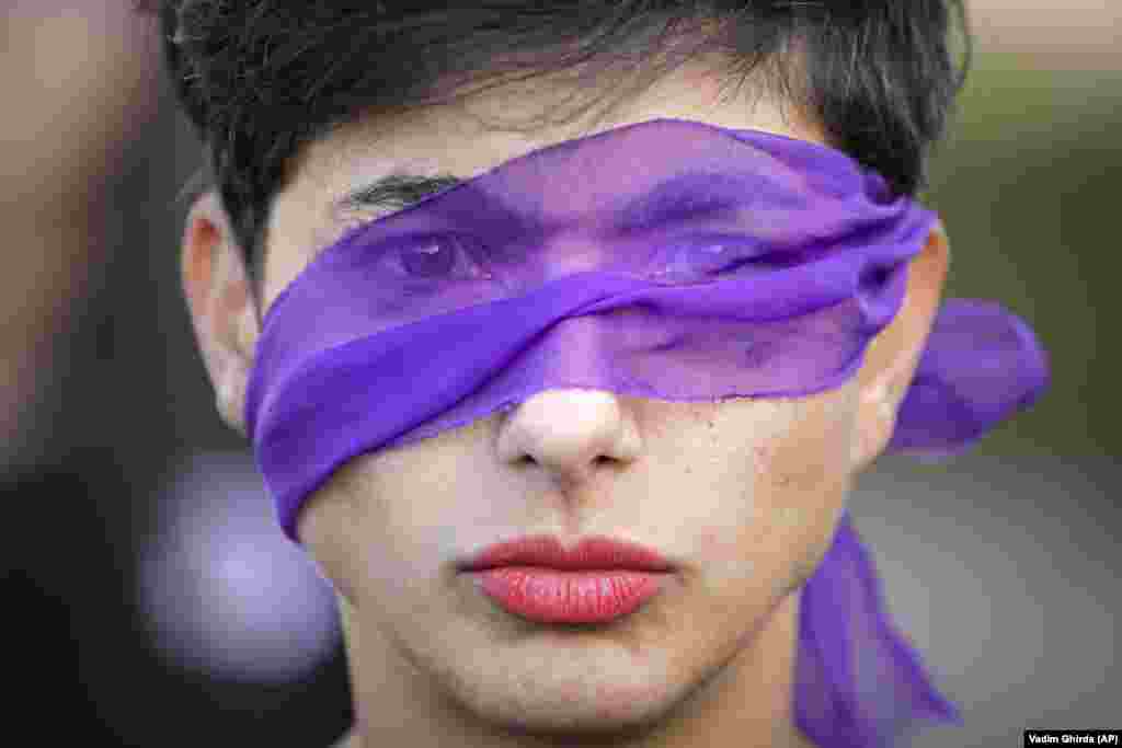 A woman takes part in a flash mob dubbed The Rapist Is You to raise awareness of the high levels of violence and prejudice against women in Bucharest. (AP/Vadim Ghirda)