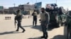 Policemen keep watch near the side of an attack in Kabul on March 7.