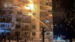 Firefighters work at the site of the apartment building hit by a Russian missile strike in the city of Balakliya, Kharkiv region, Ukraine, early on November 17.