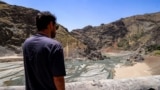 A man views the low water inlet upstream of the Amir Kabir Dam on the Karaj River in Iran's northern Alborz mountains in June.