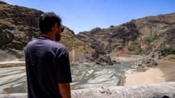 A man views the low water inlet upstream of the Amir Kabir Dam on the Karaj River in Iran's northern Alborz mountains in June.