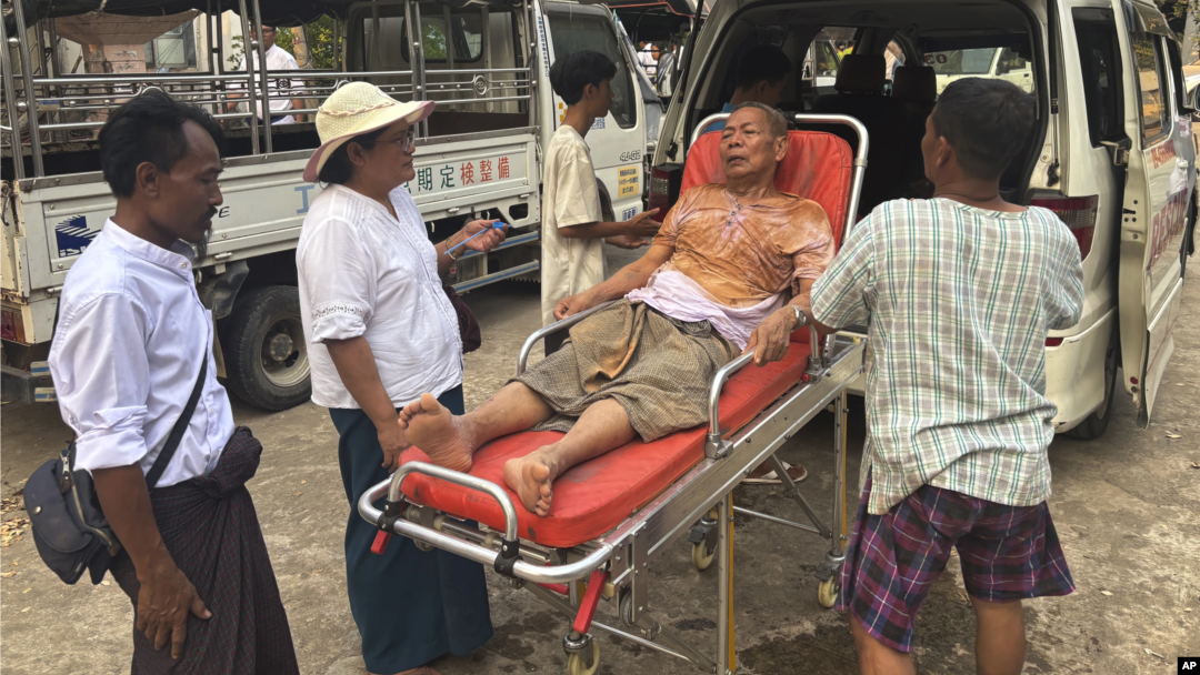 Rescue workers in the Myanmar capital, Naypyitaw, attend to an injured man who was trapped under a building following an earthquake on March 28.