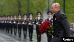 Russian President Vladimir Putin takes part in a flower-laying ceremony at the Tomb of the Unknown Soldier on May 9 in Moscow.