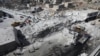 Destroyed buildings are seen following an explosion at an arms depot in a residential area in Syria's northern Idlib Province city of Sarmada on August 12.