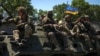 UKRAINE – Ukrainian service members ride an Armoured Personnel Carrier (APC), in Donetsk region, amid Russia's attack on Ukraine, July 7, 2022 