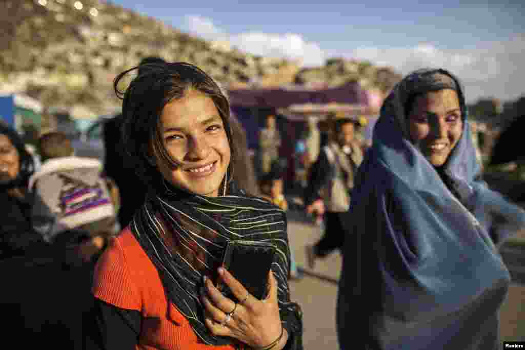 An Afghan girl smiles as she walks away after visiting the Sakhi shrine in Kabul. (Reuters/Zohra Bensemra)