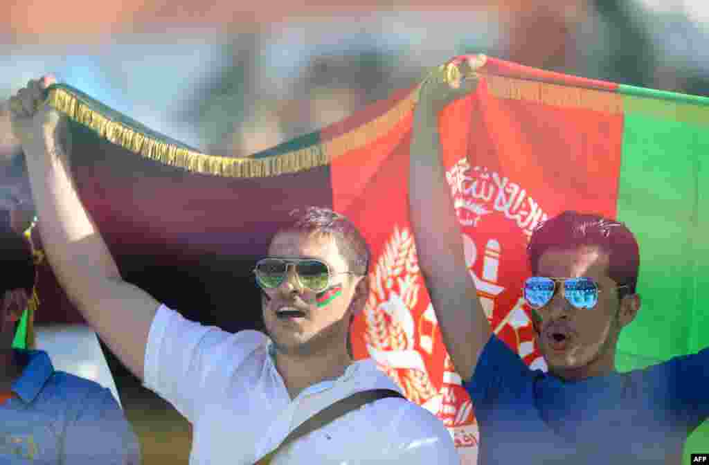 Afghan cricket supporters cheer for their team during the World T20 cricket tournament match between England and Afghanistan at the Feroz Shah Kolta Cricket Stadium in New Delhi on March 23.