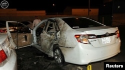 A damaged car is seen after a blast near the U.S. consulate in the Saudi city of Jeddah on July 4.