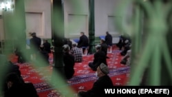 Uyghurs and others pray in the Id Kah Mosque in Kashgar in western China's Xinjiang Uyghur Autonomous Region during a government-organized trip for foreign journalists in April. 