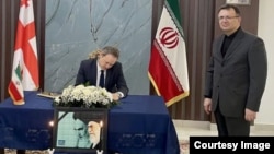 საქართველოში შვეიცარიის საელჩოს რუსეთის ინტერესების სექციის ხელმძღვანელi, დმიტრი ოლისოვი სამძიმრის წიგნში ჩანაწერს აკეთებს.