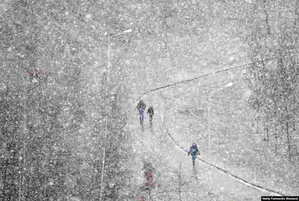 People walk during heavy snowfall in Minsk, Belarus. (Reuters/Vasily Fedosenko)