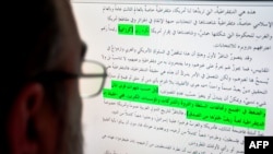 A journalist studies original documents recovered from Osama Bin Laden's compound that were released May 3 by the Combating Terrorism Center at the U.S. Military Academy.